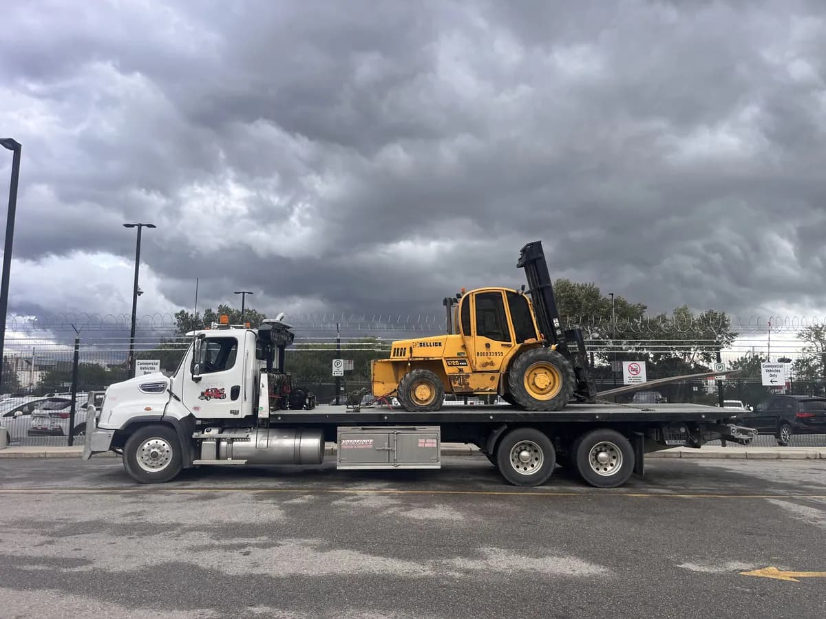 Forklift secured on a Notorious Towing flat deck